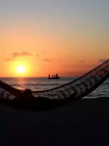 Sunset at Marari Beach with hammock and fishermen